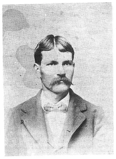 Studio head-and-shoulders portrait of a man with a large mustache, wearing a suit and bow tie.