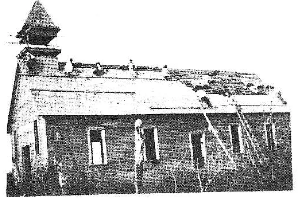 Photograph of men working on the construction of St. Joseph's Latin American Church (a wood-frame building under construction, roof partly built), later converted into St. Anthony's Hall