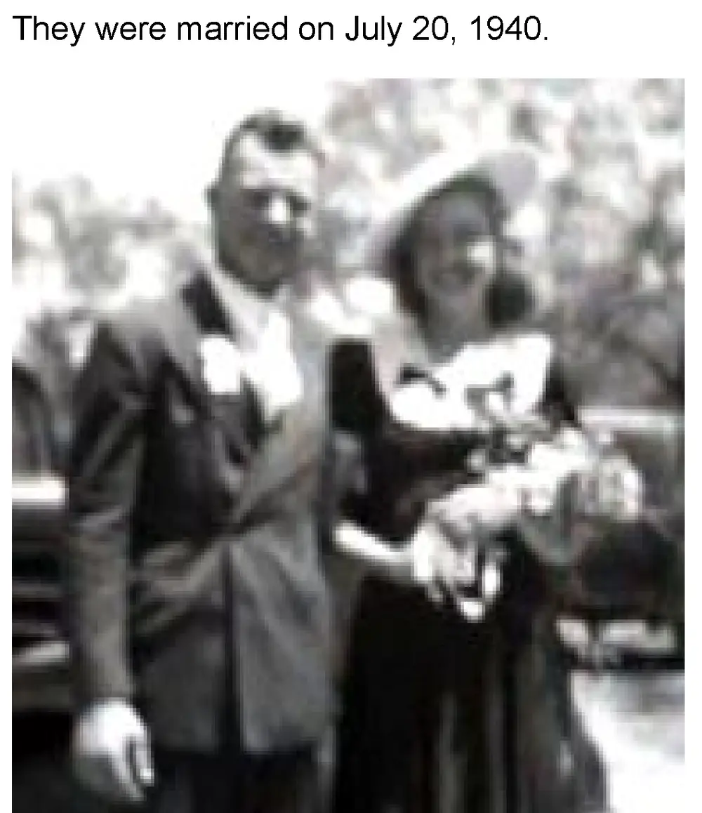 Black-and-white wedding photograph, blurred/soft-focus, showing a bride and groom standing together, the bride holding a bouquet